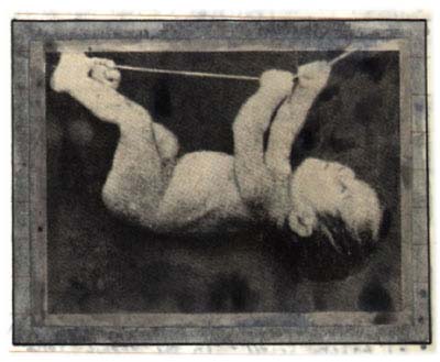Baby hanging onto string